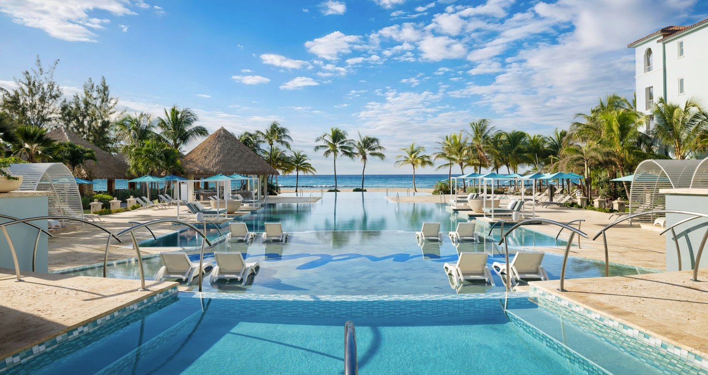 Sandals Royal Barbados pool with in-water loungers, palms, and ocean views